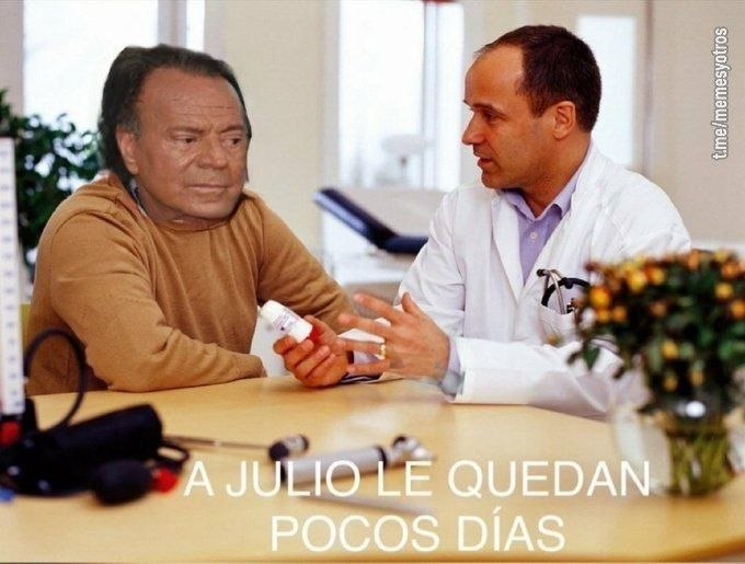 a man sitting at a table with a man in a white coat